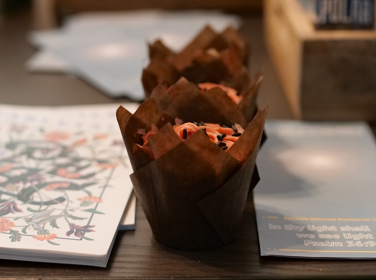 Strawberry cupcakes, Tabletalk magazine, and an Associate Reformed Presbyterian Church denominational flyer.