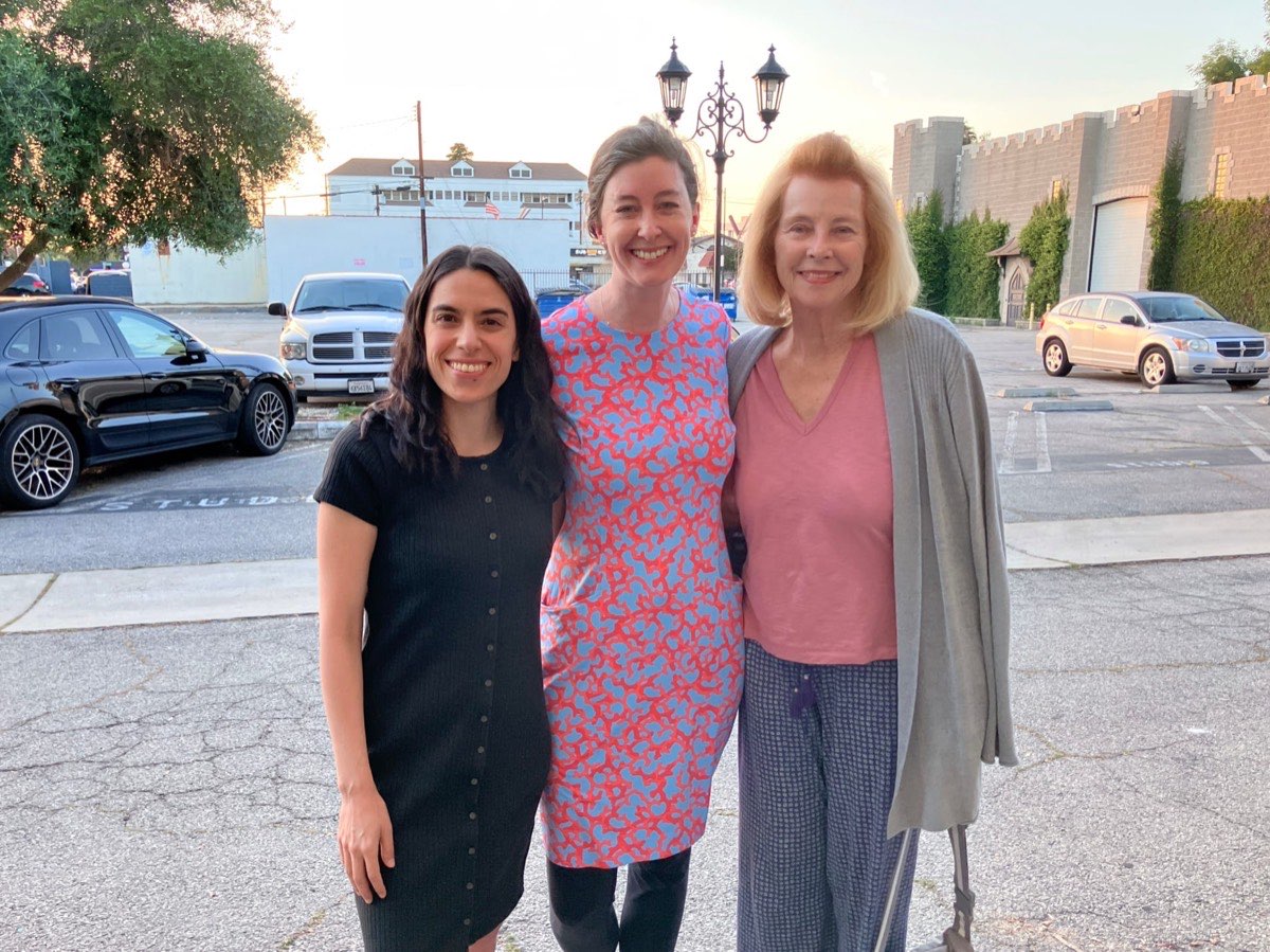 Three members of Covenant Church smiling together at an evening fellowship in Burbank.
